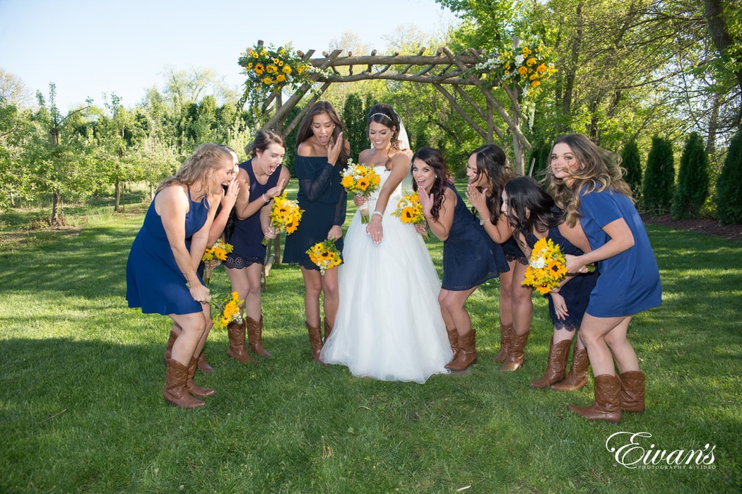 All of the bride's closest friends smile and gawk at their best friend's new and beautiful placed on her finger.