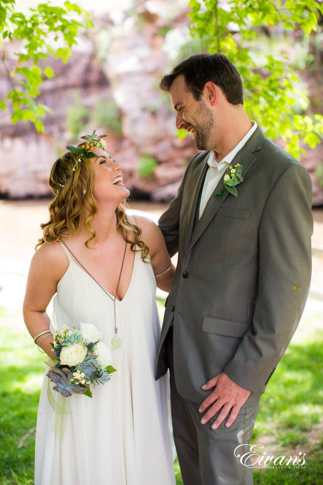 man in black suit and woman in white wedding dress