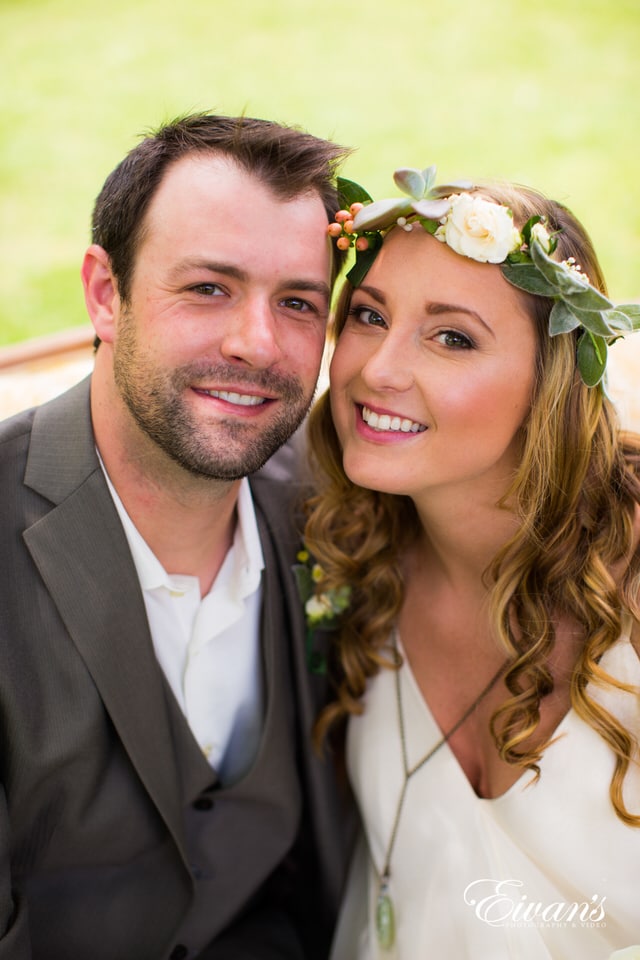 man in black suit jacket beside woman in white dress