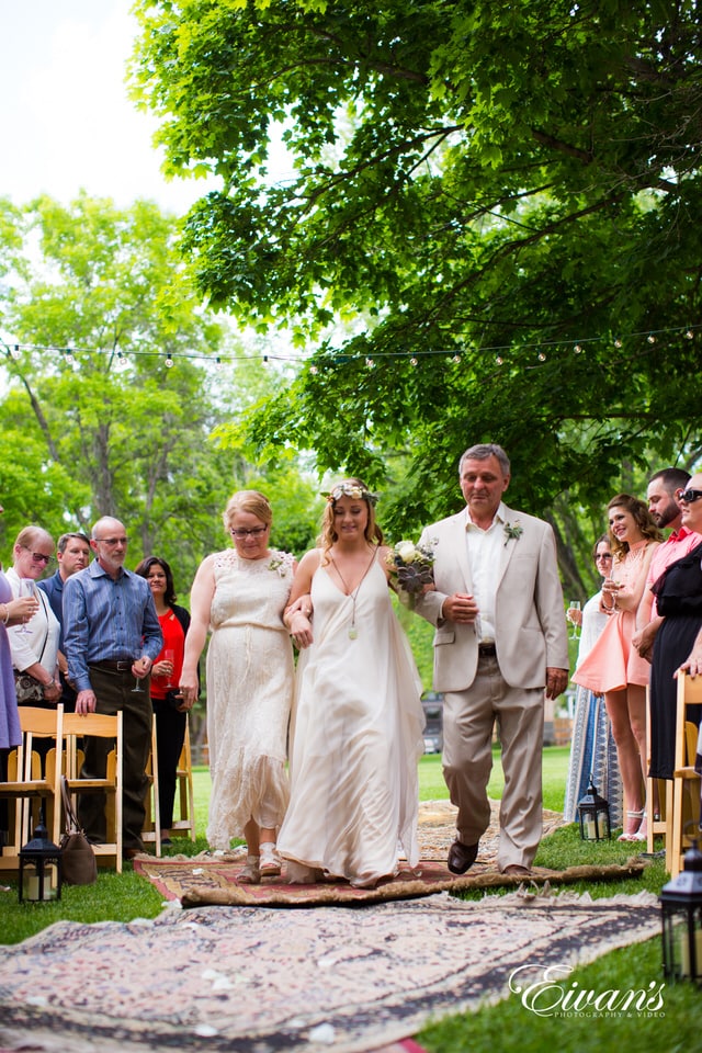 woman in white long sleeve dress standing beside man in white suit