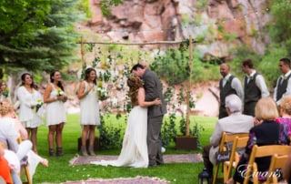 bride and groom standing on green grass field during daytime