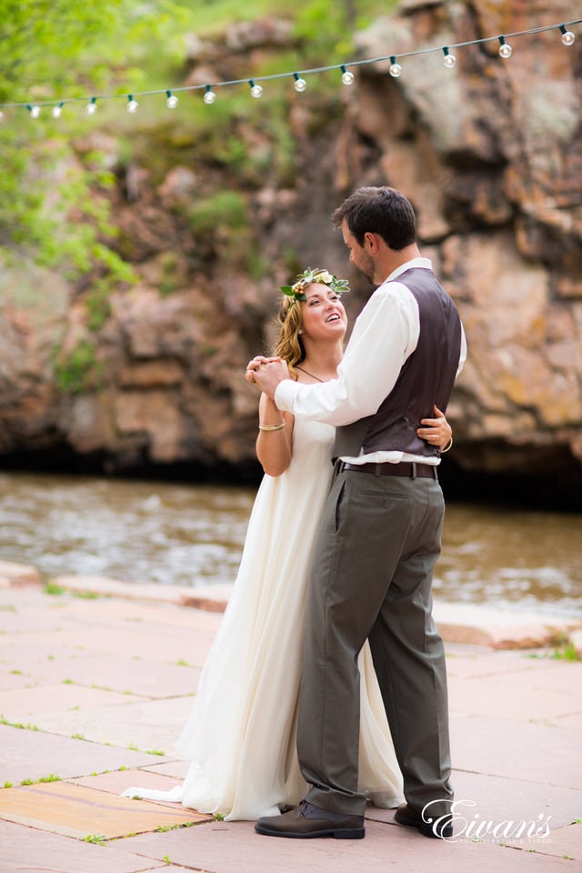 man and woman kissing near body of water during daytime