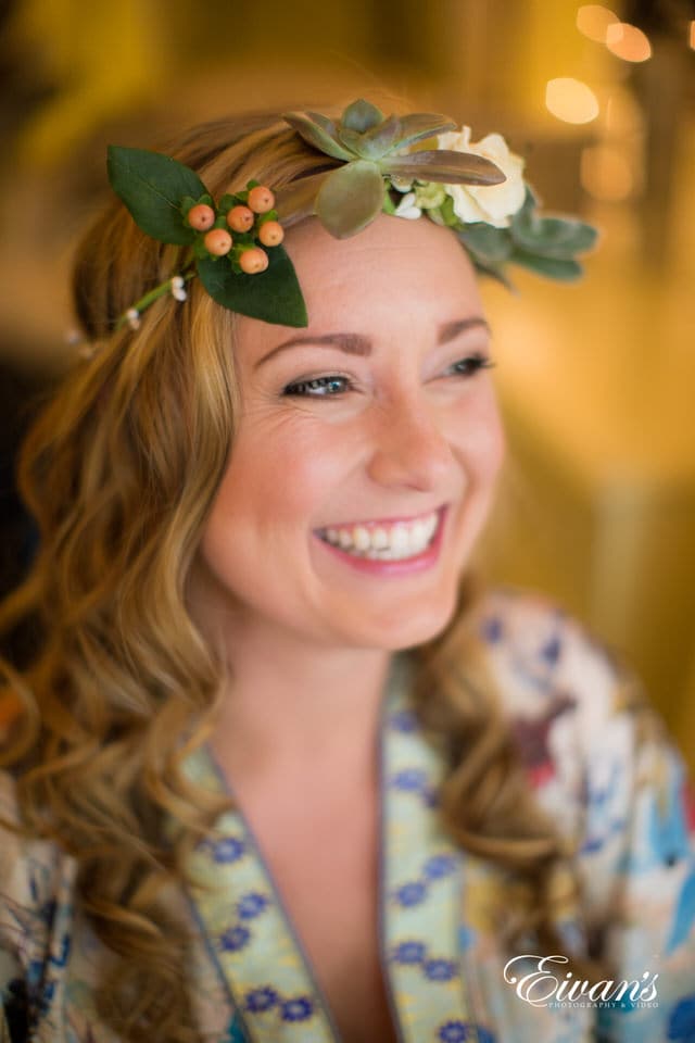 woman in white and green floral dress smiling