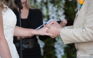 The groom slips the final wedding band onto his lover's finger permitting their love.