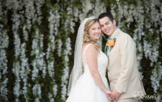 The bride and groom stand face-to-face just smiling and gazing into their amazing future together.