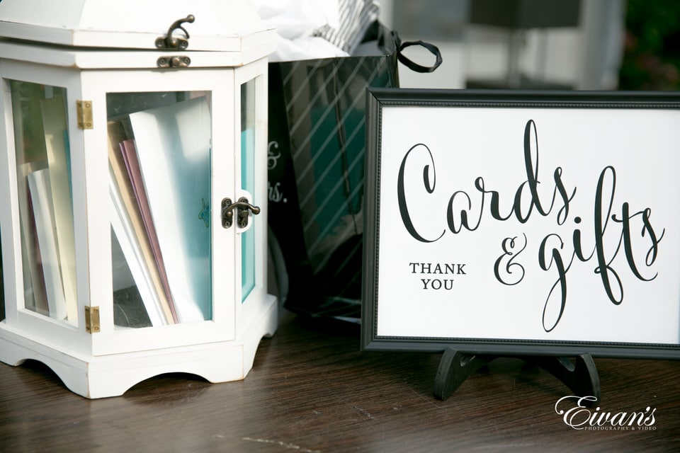 A thank you card example along with a small chest of stationary paper products.