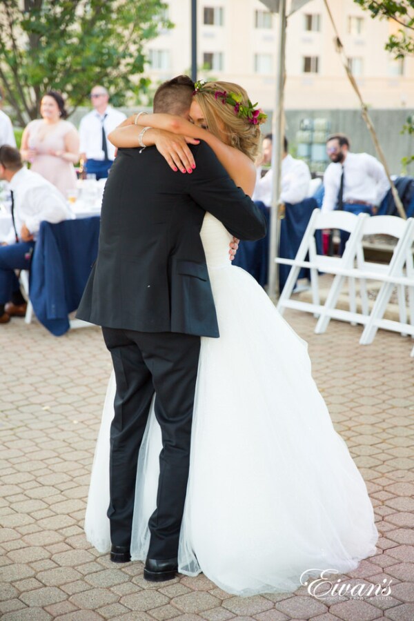 Amelia & Farron Gaerte A bride and groom envelop in a tight hug during a dance at their reception.