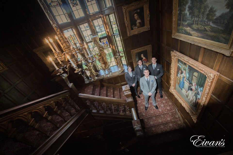 A beautiful old-aged stairwell portrait of the groom and his men.