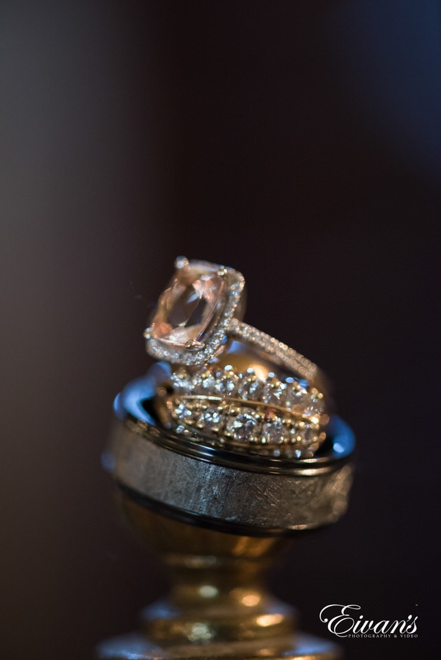 The photographer stacked the rings and wedding bands atop one another for a beautiful detail shot.