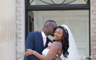 Kissing his new wife's cheek making her smile with only true love and excitement.