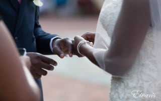 Placing the ring on her soon-to-be husband's finger ready for the lovely new steps into the future married life.