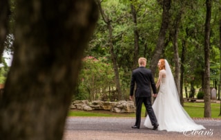 The couple strolls down a beautiful nature pathway celebrating their new found love.