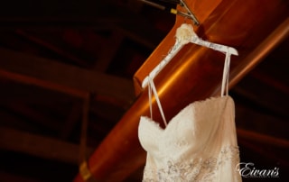 The hanger holding the bride's gown has her soon-to-be new last name.