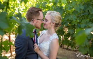 Gazing into one another's eyes while standing in the vineyard that only helps encompass their love and time.