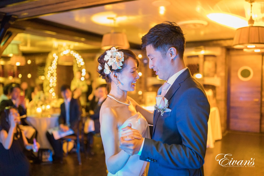 The couple dances together in a beautiful winery feeling the love in the air.