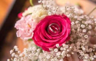 Within the gorgeous hot pink rose it holds the rings that will solidify their love.