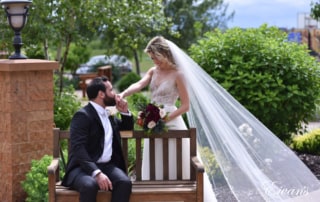 The groom kisses the bride's hand in a moment of happiness and joy together.