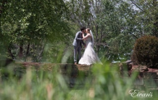 The couple kiss in the beautiful and thriving nature environment.