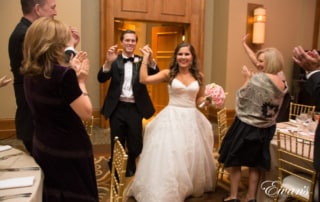 The bride and groom run into their reception celebrating their love and this ever so perfect day.