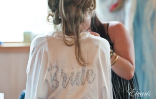 The bride wears a robe before putting on her beautiful gown. On this robe is bride written in all sorts of dazzling rhinestones.