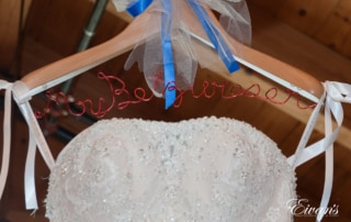 On the bride's hanger is her new soon-to-be last name with her stunning wedding gown.