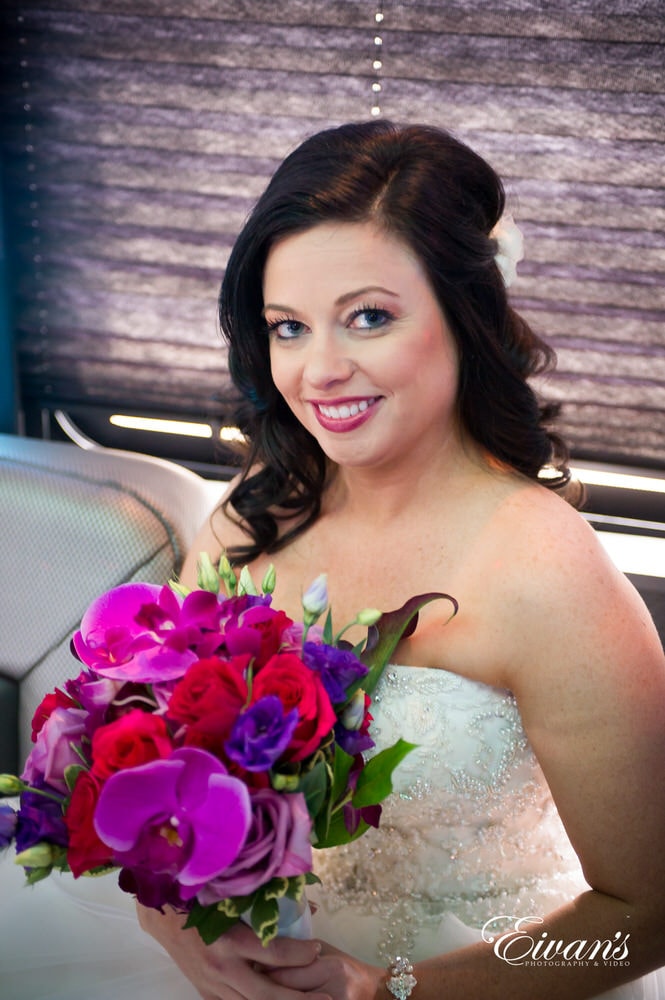 The bride smiles with pure joy and happiness while she prepares for her perfect day.