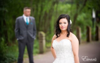 The bride looks absolutely effortless while standing in front of her groom.