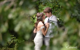 the bride and groom stand nose-to-nose gazing into one another's hopeful eyes.