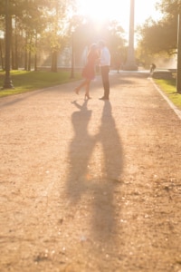 eivans_gallery_engagement_photos_141 The beautiful sun is shining down on this couple as they demonstrate their love while walking along a gravel path. The sun radiating on this couple only gives this couple an eternal glow to develop their everlasting love.