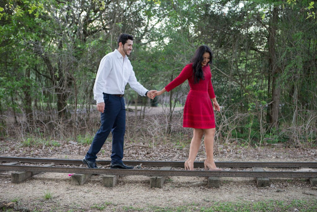 This smiling couple walks along this tremendous and beautiful railroad almost encompassing a dangerous feel to this stunning engagement.