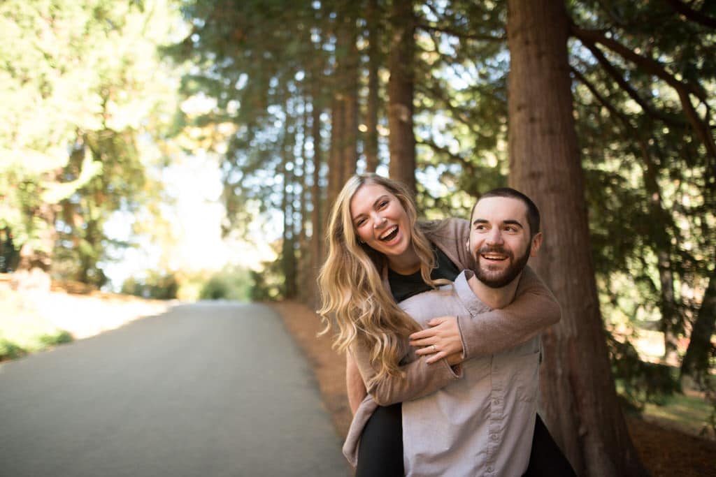 The gorgeous woods and even more stunning couple celebrate their never ending love while the soon-to-be groom carried his fiance on his back while they smile and laugh their worries away.