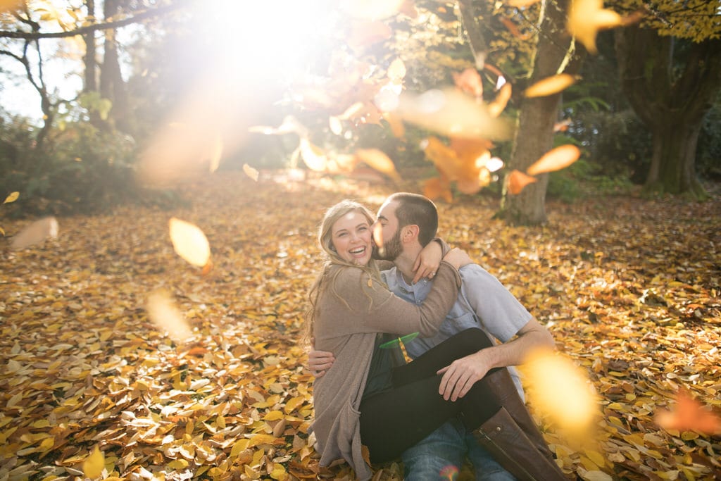 Bright yellow and orange leaves fall on the laughing couple as they begin to celebrate their love and soon-to-be solidified marriage. The fall colors truly make the couple glow exponentially which captures all of their love.