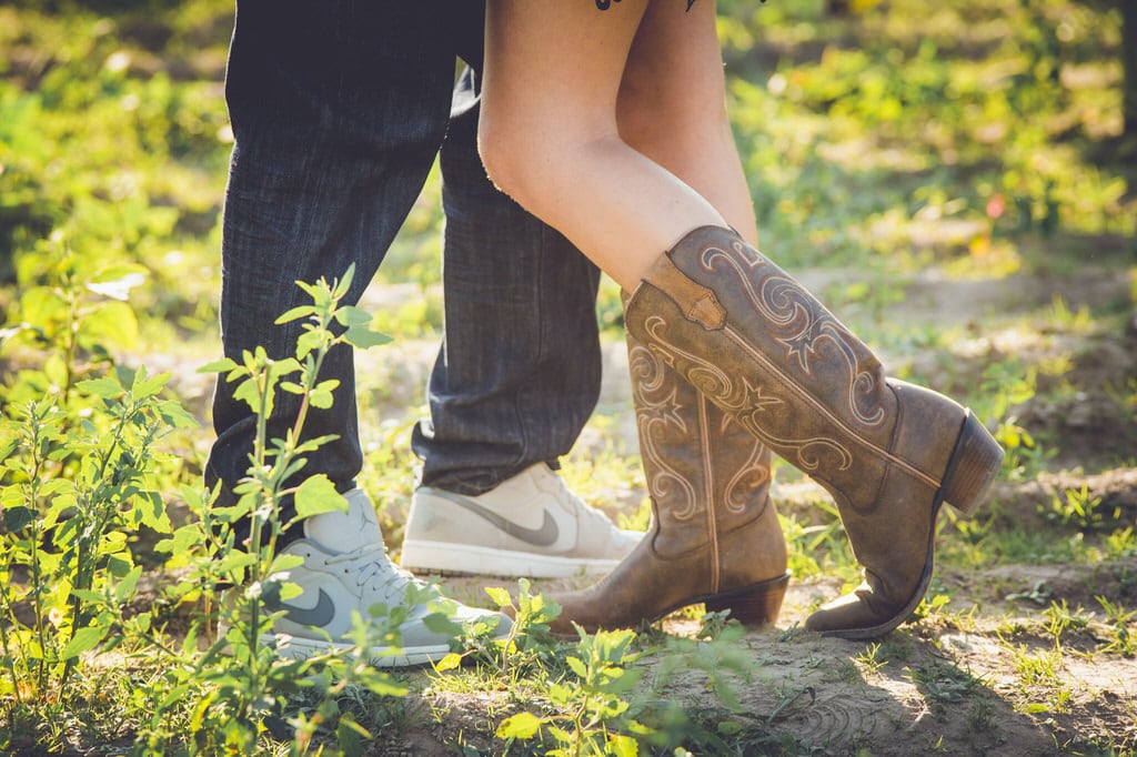 The rustic cowboy boots worn by this soon-to-be bride give a very rustic feel that is also enhanced by the bright and vibrant greens. Even based on the placement of the couple's feet you can tell that they love one another.