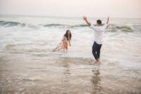 Wedding / Engagement Photography This beautiful couple is captured in a candid moment by this Eivan photographer as they play in the ocean just enjoying one another's company. You can see just how much they want to be together.