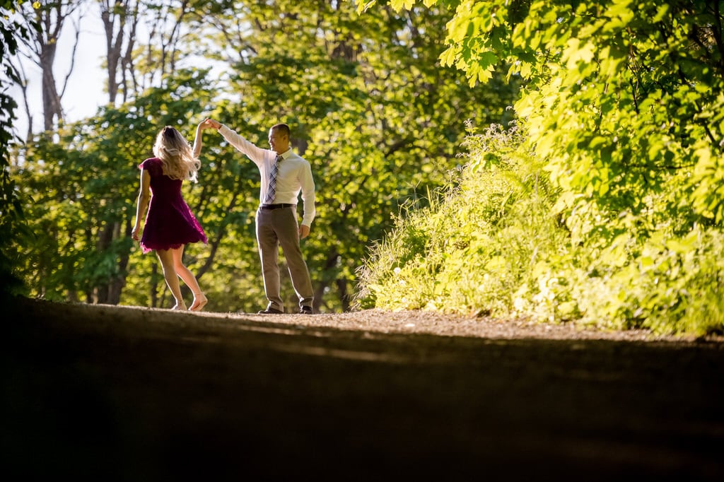 Twirling his soon-to-be wife in the middle of a beautiful green forest. The couple spends this moment with one another just cherishing this shining memory and the possibilities of a thousand more.