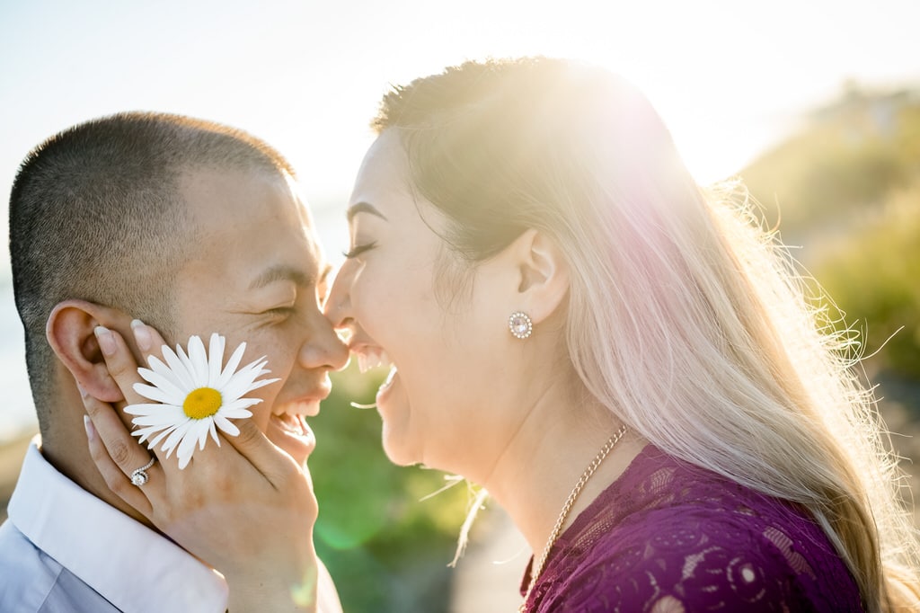 engaged man and woman close to each others faces laughing