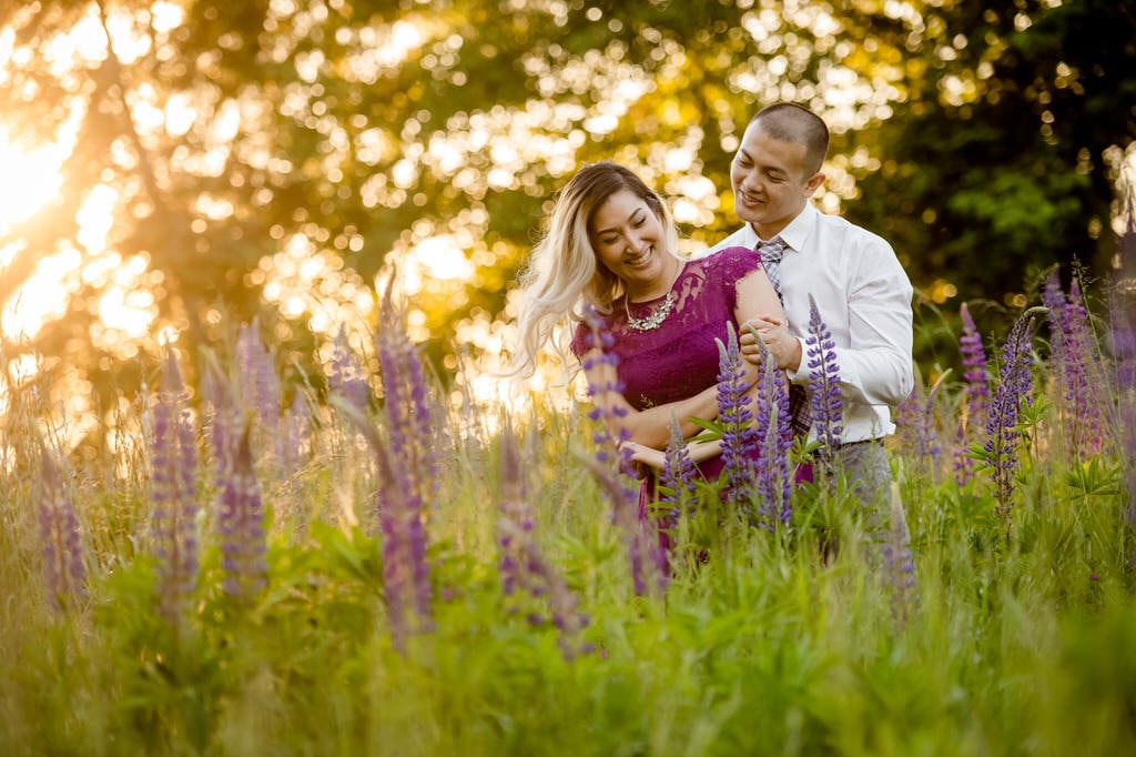 The bright sun, vivid greens, and vibrant purple flowers give this couple the perfect environment