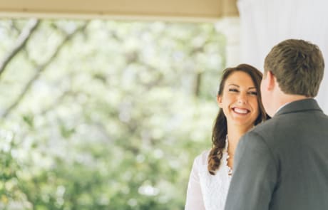 newlywed woman smiling staring at her her groom, photographed by Eivan's in Dallas