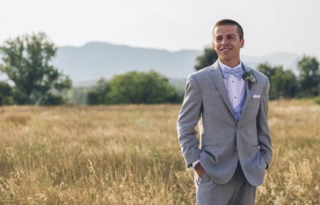 newlywed groom in a yard, denver wedding photographer packages and pricing