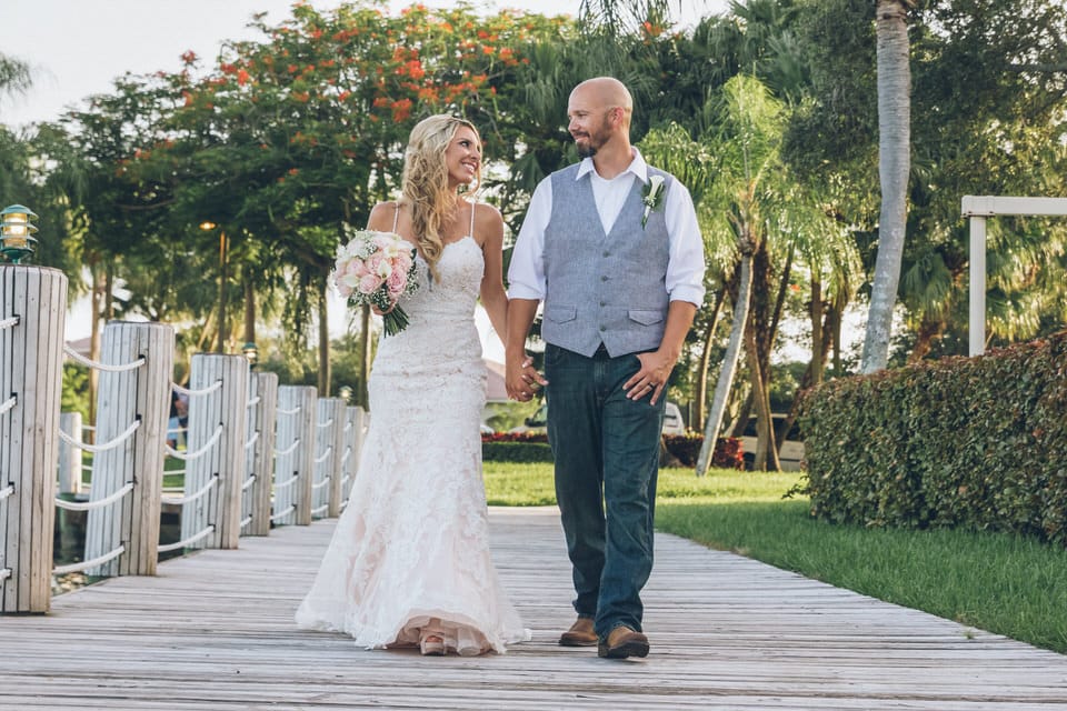 newlyweds walking hand in hand, miami wedding photographer availability