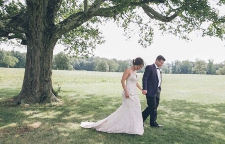 newlyweds laughing next to a tree, photographed by Eivan's in Hartford