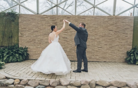 man and woman kissing on brown brick wall