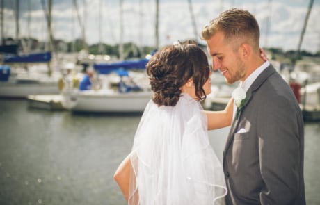 man in black suit kissing woman in white dress