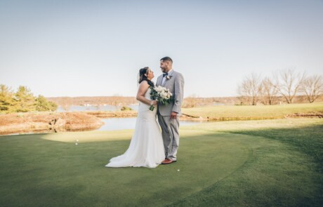 man and woman kissing on green grass field during daytime