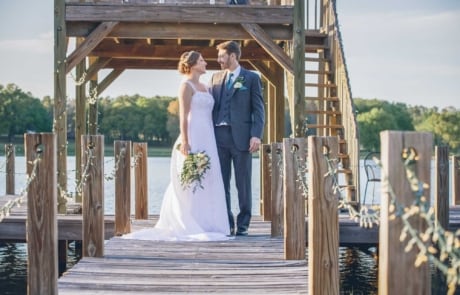 newlyweds happy at wooden deck, photographed by Eivan's in Orlando