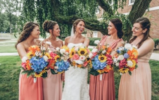 woman in red tube dress holding bouquet of flowers