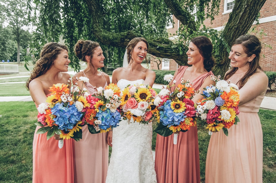 woman in red tube dress holding bouquet of flowers