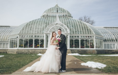 bride and groom standing on green grass field