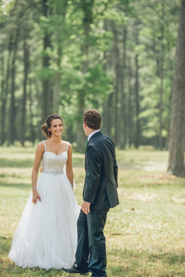 newlyweds walking in a forest, washington wedding photographer availability