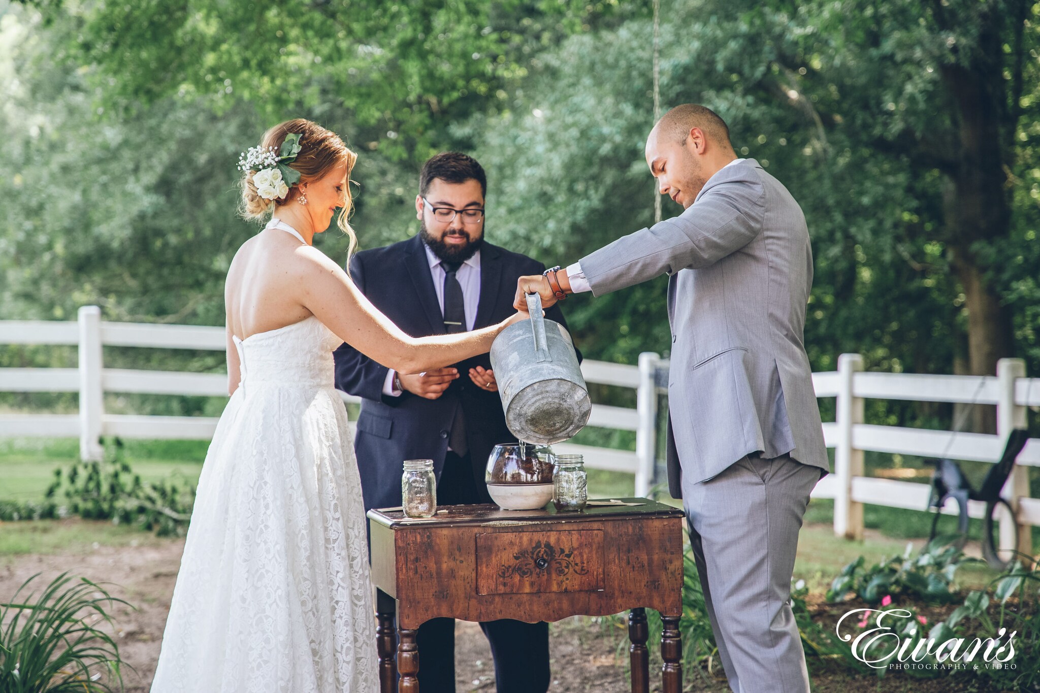 man and woman at the alter doing a sand ceremony